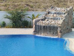 a waterfall in the middle of a swimming pool at Venus Resort & Coffee House in Bāndarban