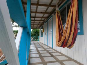 a building with a porch with hammocks hanging from it at Ketlina Village in Providencia
