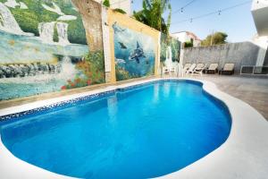 una piscina frente a una pared con una pintura en Luxurious 1-Bed 1 Bath, en Las Flores