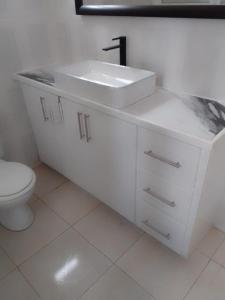 a white bathroom with a sink and a toilet at Modern Air Conditioned Home For Family & Adventure in Loubiere