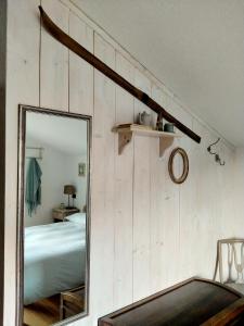 a mirror in front of a bedroom with a bed at Lo noú in Aosta