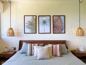a bedroom with a bed with four pictures on the wall at Hermoso Departamento Con Vista Al Mar in Holbox Island