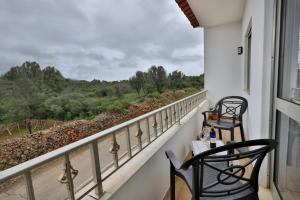 a balcony with two chairs and a view at Casa Sol Nascente in Silves