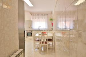 a kitchen with a white table and a table and chairs at Casa Sol Nascente in Silves