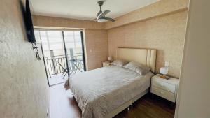 1 dormitorio con 1 cama y ventana con balcón en Hermoso departamento nuevo cerca a servicios, en Lima