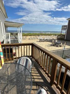 a balcony with a table and a view of the beach at Echo Motel in Old Orchard Beach