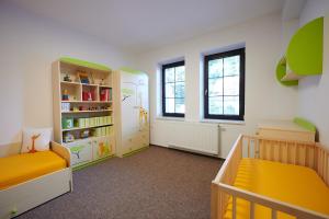 a nursery with two beds and a book shelf at Penzion Počátky Seč in Seč