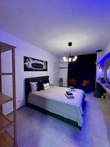 a bedroom with a large bed and a couch at Fat Cow Apartment 01 in Larnaka