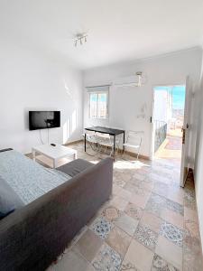 a bedroom with a bed and a table in it at Gran Teatro Falla in Cádiz