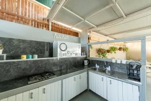 a kitchen with white cabinets and a sink at Villa Li Eilat in Eilat +17 photos