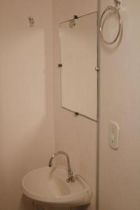 a bathroom with a sink and a mirror on the wall at Casa Azul Caraíva - Casas Do San in Caraíva +38 photos