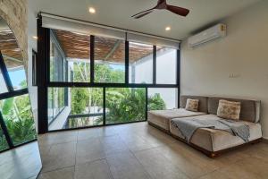 a large bedroom with a bed and large windows at Casa Aventura Secluded Oasis 24h Security Near Sandy Beaches in Tulum +100 photos