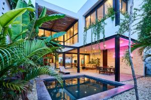 a house with a pool in front of it at Casa Aventura Secluded Oasis 24h Security Near Sandy Beaches in Tulum