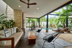 a living room with a couch and chairs at Casa Aventura Secluded Oasis 24h Security Near Sandy Beaches in Tulum