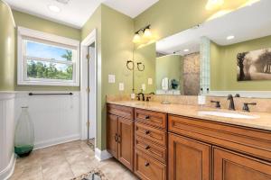 a bathroom with two sinks and a large mirror at Edgewatermayo Getaway! in Edgewater