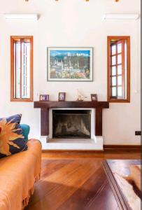 a living room with a fireplace and a couch at Casa na Granja Viana - Cotia in Cotia
