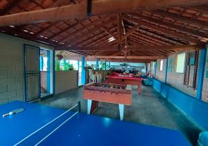 a large room with blue tables in a building at Rancho Morada do Sol in Areado