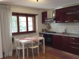 a kitchen with a small table and a table and chairs at Mostacciano Roma IFO in Rome