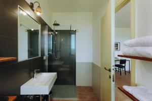 a bathroom with a sink and a shower at Il Vecchio Braciere in Civitella deʼ Conti +50 photos