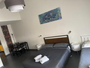 a bedroom with a bed and a table with a chair at Appartamenti ClesioResidenceBuonconsiglio in Trento