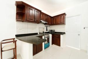a kitchen with wooden cabinets and a counter top at Breathtaking 3-2 with Ocean View in Las Flores