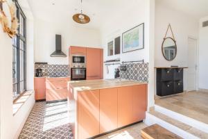 a kitchen with orange cabinets and a counter at Family home with garden in Toulon - Welkeys in Toulon