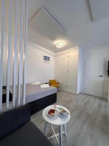 a room with a bed and a table with a cake at Apartament Londyn Zdrój 16 in Lądek-Zdrój