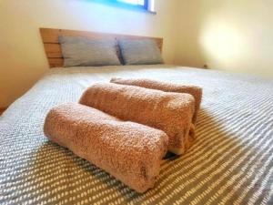a bedroom with a bed with two ottomans on it at Cute & Cosy Apartment Emi in Koper