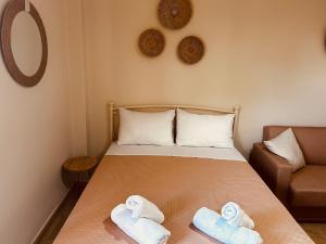 a bedroom with a bed with towels on it at Central House Karistos Two in Karistos