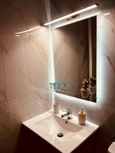 a bathroom with a sink and a mirror at Central House Karistos Two in Karistos +26 photos