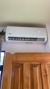 a white air conditioner on top of a wall at Suite de Asdruval in Puerto Baquerizo Moreno