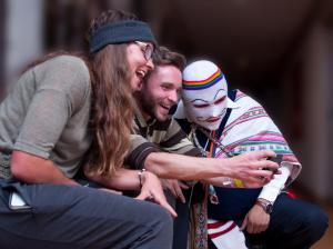 a woman hugging a man dressed in a mask at Pariwana Hostel Cusco in Cusco