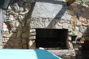 a stone wall with a stone oven in a building at Studio Bilka in Komiža