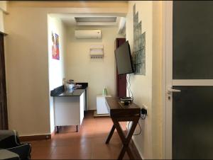 a room with a desk and a tv in it at Serviced studio Apt at CBD in Dar es Salaam