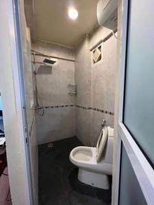 a small bathroom with a toilet and a sink at Serviced studio Apt at CBD in Dar es Salaam