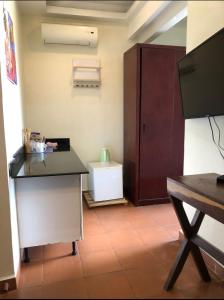 a room with a desk and a cabinet and a table at Serviced studio Apt at CBD in Dar es Salaam