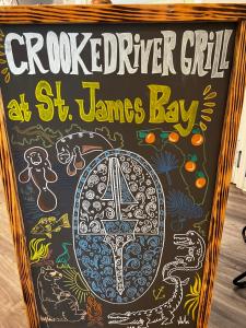 Eine Kreidetafel mit der Aufschrift „Crookedvelt Girl“ in St. James Bay in der Unterkunft St James Golf Resort 331 Penthouse 3/3 sleeps 8 gated pool 1dog ok in Big Blackjack Landing