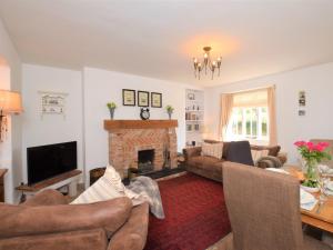 uma sala de estar com sofás e uma lareira em 2 Bed in Brixham 74200 em Churston Ferrers