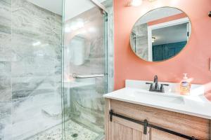 a bathroom with a shower and a sink and a mirror at Eagleville Home with Porch, Near Valley Forge Casino in Eagleville