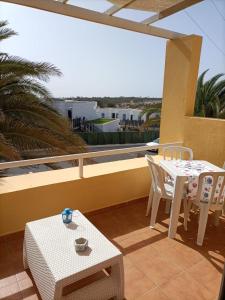 a patio with a table and chairs on a balcony at Casa Serena in Costa Calma +32 photos