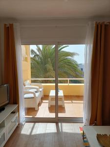 a living room with a sliding glass door to a patio at Casa Serena in Costa Calma