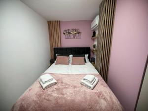 a bedroom with a bed with two towels on it at Luxury Benidorm Apartments in Benidorm
