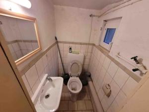 a bathroom with a toilet and a sink at House in Sarstedt! contactless check-in 20P in Sarstedt