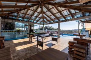 a patio with ping pong tables and a pool at EDMA APARTAHOTEL in Santa Bárbara de Samaná