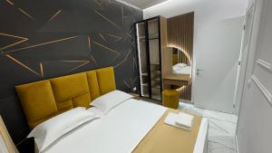 a bedroom with a bed and a desk and a mirror at Apartments Costa Azzurra in Velipojë