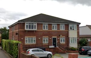 a brick house with a car parked in front of it at St Marks Court Apartments in Anlaby