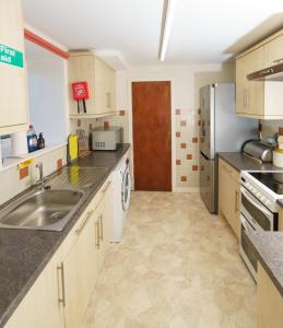 a kitchen with a sink and a refrigerator at Achloist Holiday Cottage in Drumbeg