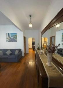 a living room with a blue couch and a table at ΠΟΛΥΞΕΝΗ -ΕΚΑΒΗ in Kondiás