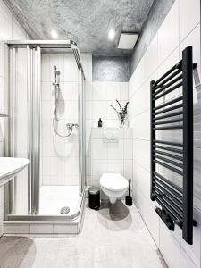 a white bathroom with a shower and a toilet at SI-View Doppelzimmer mit Stadtblick Zimmer 22 - Hotel in Siegen