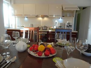 a table with a plate of fruit and wine glasses at Zinnowitz, Fewo Sonnendomizil in Zinnowitz
